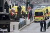Police patrol near ambulances at a staging station near a metro after an explosion in Brussels on Tuesday, March 22, 2016. Explosions, at least one likely caused by a suicide bomber, rocked the Brussels airport and subway system Tuesday, prompting a lockdown of the Belgian capital and heightened security across Europe. At least 26 people were reported dead. (AP Photo/Virginia Mayo)