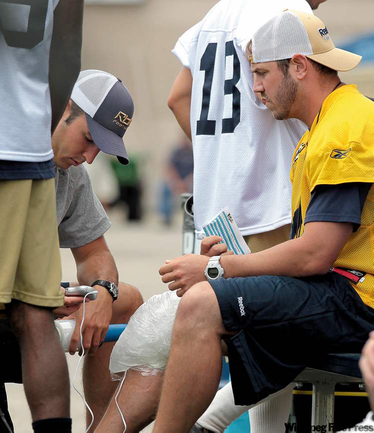 JOE.BRYKSA@FREEPRESS.MB.CA
Injured Bombers starting quarterback Buck Pierce gets his knee iced by training staff during practice Thursday.