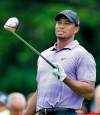TONY DEJAK / THE ASSOCIATED PRESS
Tiger Woods reacts after hit­ting his tee shot on the ninth hole in the second round of the Bridgestone Invitational at Firestone Country Club on Friday at Akron, Ohio. He bogeyed the hole and finished at 6-over par after two rounds.