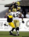 J.P. MOCZULSKI / THE CANADIAN PRESS
Hamilton receiver Dave Stala leaps and hauls in a fourth-quarter TD pass over Winnipeg defender Bernard Hicks Saturday.
