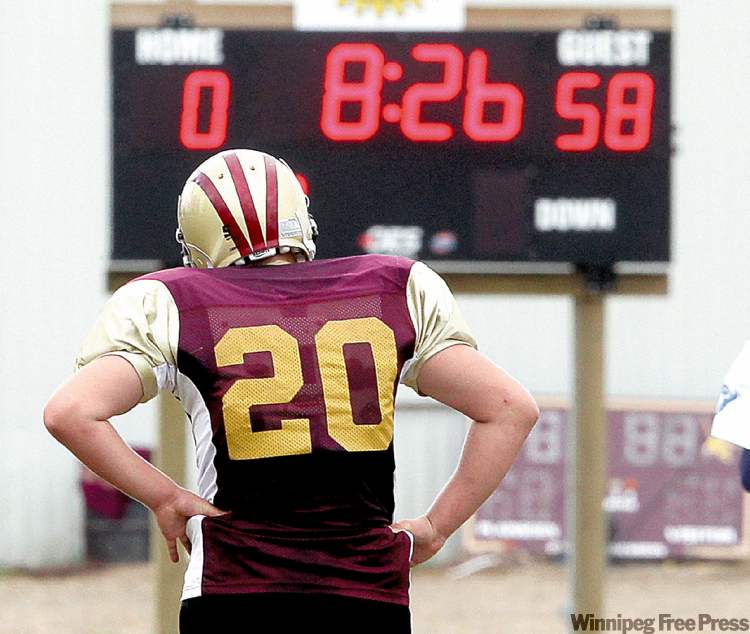 COLIN CORNEAU / BRANDON SUN
Crocus Plains' Victor St. Pierre walks past scoreboard before the half in a match with Oak Park.