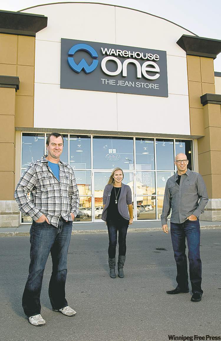 DAVID LIPNOWSKI / WINNIPEG FREE PRESS
From left, Warehouse One chief operating officer Neil Armstrong, Kenaston store manager Amanda Croy, and director of marketing Larry Millar at the Kenaston store. The chain is breaking sales records and spending millions on rebranding.