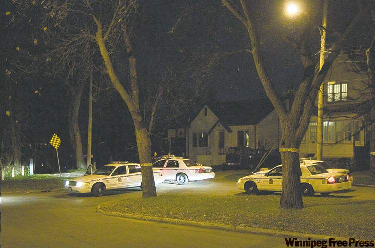 david lipnowski / winnipeg free press
City police search for suspect in Saturday's shootings at the end of Burrows Avenue by the Red River.
