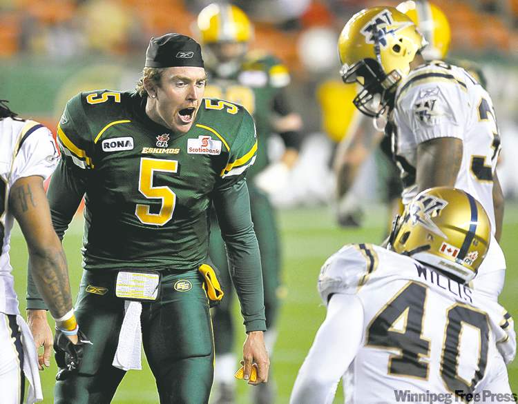 SHAUGHN BUTTS / POSTMEDIA NEWS
Edmonton quarterback Jared Zabransky (5) exchanges words with Bombers defensive end Odell Willis after a hard tackle.