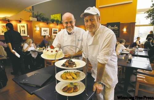 RUTH.BONNEVILLE@FREEPRESS.MB.CA
Executive Chef Gord Harris (left) and master baker Eric Bari with Prairie Ink's three-tiered appetizer tray and a white strawberry cake.