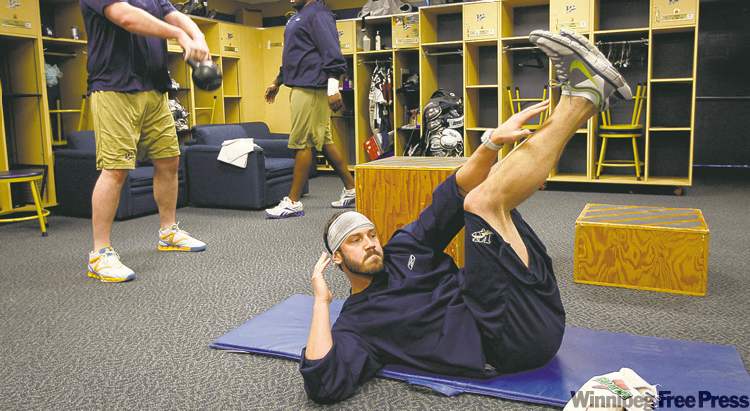 KEN GIGLIOTTI / WINNIPEG FREE PRESS
For quarterback Buck Pierce (foreground), the long road to recovery travels through the Bombers training room, working out with offensive linemen Steven Morley (left) and Kelly Butler.