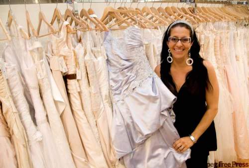 DAVID LIPNOWSKI / WINNIPEG FREE PRESS
Tammy Mignacca of Stella's Bridal shows off a Paraezo wedding dress.