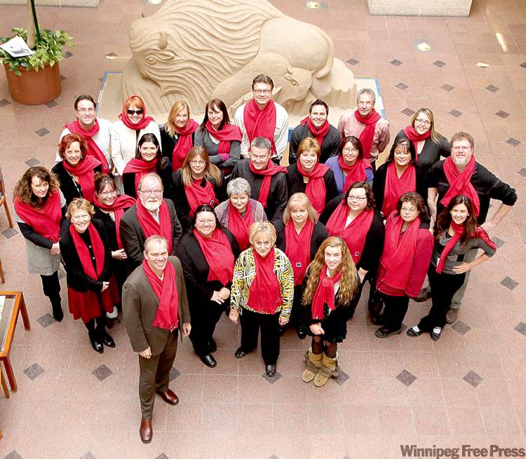 MIKE.DEAL@FREEPRESS.MB.CA
Hannah Taylor (front right), posing with Free Press staff, wants you to buy a red scarf and join her walk.