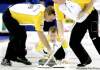 Dave Chidley / The Canadian Press
Manitoba's Jeff Stoughton takes dead aim while Reid Carruthers (left) and Steve Gould (right) keep the stone's path clean during Sunday's win over Nova Scotia.