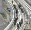 KOJI SASAHARA / THE ASSOCIATED PRESS
Would-be train passengers walk on the elevated track towards Shiodome Station in Tokyo.