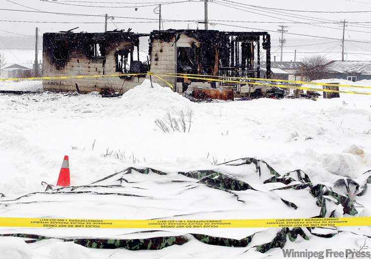 Ken Gigliotti/ Winnipeg Free Press
Police tape marks the scene of the shooting in front of a house that burned on Monday, killing three.