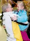 DAVID LIPNOWSKI / WINNIPEG FREE PRESS
Robertson third Doug Armour gets a hug from granddaughter Emerson, 4, at the airport Sunday night.