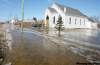 Bruce Bumstead/Brandon Sun
PHOTOS by Bruce Bumstead / Brandon Sun Water crosses the main street in Douglas, Man., passing the church in the small community east of Brandon Wednesday.