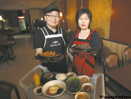 MIKE.DEAL@FREEPRESS.MB.CA
Nou Eul Tor owners Jay Yoo and wife Ju Hee Kim with a variety of dishes from their excellent menu.