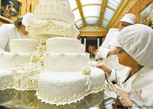 JOHN STILLWELL / ASSOCIATED PRESS
Members of the team put the finishing touches to the royal wedding cake.