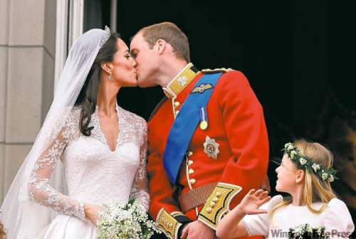 John Stillwell / The Associated Press
Prince William and his wife Kate, Duchess of Cambridge, kiss on the balcony of Buckingham Palace in London.