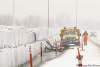 Tim Smith / Brandon Sun
Workers in Brandon pump water seeping under a sandbag dike back over the dike into Dinsdale Park as snow falls on Saturday.