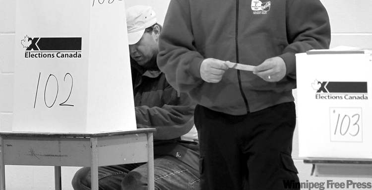 WAYNE.GLOWACKI@FREEPRESS.MB.CA
Voting Monday morning at Faraday School in the North End. The campaign’s twists and turns did little to mobilize many new voters.