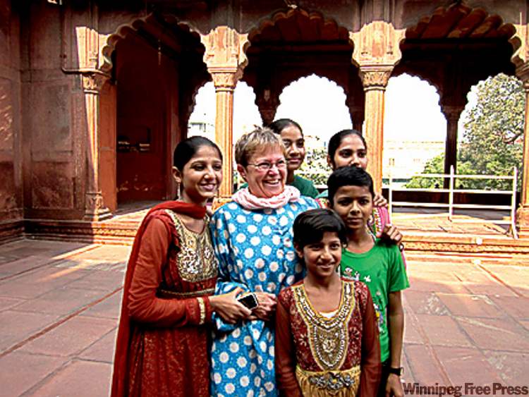 Postmedia
Riley, wearing the compulsory cover-up gown given to all foreigners, is asked to pose with a vacationing Indian family at Delhi's Red Fort.