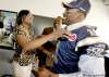 CP
john woods / the canadian pressNew Blue Bomber Henoc Muamba gets a hug from mother Louise as father Germain looks on Sunday at Canad Inns Stadium.