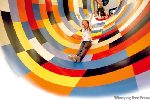 Photos by Ken Gigliotti/ Winnipeg Free Press
Emily Cox, 6, slides down Illusion Tunnel at the Manitoba Children's Museum.