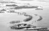 JOE.BRYKSA@FREEPRESS.MB.CAFarm fields lie flooded along the Red River north of St. Jean Baptiste last April.
