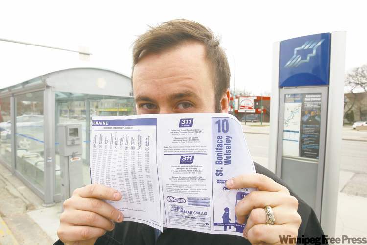 BORIS.MINKEVICH@FREEPRESS.MB.CA
Bus blogger Jaimz Asmundson maintain his anonymity behind a bus schedule.