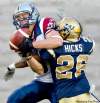 Paul Chiasson / the canadian press
Alouettes wide receiver Eric Deslauriers hauls in a pass despite close coverage by Blue Bombers defensive back Arington Hicks.