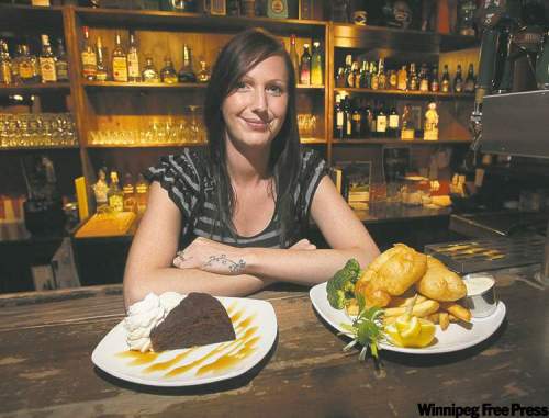 MIKE.DEAL@FREEPRESS.MB.CA
Sawney Beans owner Jackie Bakx serves some nicely done fish and chips and a slice of outstanding sticky toffee pudding.