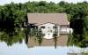 CP
CHARLES REX ARBOGAST / THE ASSOCIATED PRESSA home on the west side of Minot, N.D., is surrounded by Souris River water.
