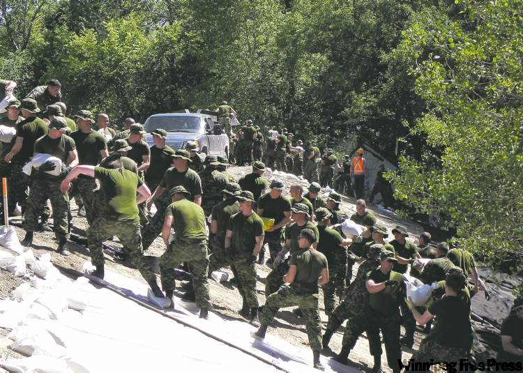 CP
the canadian press / province of manitoba handout
Soldiers from CFB Shilo were called out Saturday to reinforce flood defences in Souris.