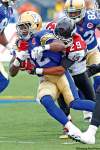 John Woods/Winnipeg Free Press
John Woods / Winnipeg Free Press
Winnipeg running back Fred Reid (32) is wrapped up by Calgary defender Geoff Tisdale during first-half action.