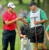 Ed Suba Jr. / Akron Beacon Journal / MCT
So far, Steve Williams (right) seems to be doing better without Tiger than Tiger is doing without him. His man Adam Scott shot 62 and has the lead.