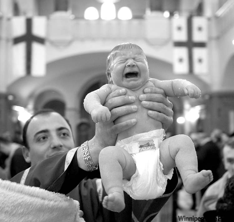 Shakh Aivazov / The Associated Press Archives
A baby cries while being baptized at Holy Trinity Cathedral in Tbilisi, Georgia.