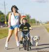 Trevor Hagan / Winnipeg Free Press
Sarah Gensorek, 23, with her four-year-old son, Seth, and dog, Rufus, on the Northeast Pioneers Greenway Trail between Gateway and Raleigh, in North Kildonan. Sarah and Seth try to get out to rollerblade and bicycle on the trail at least once or twice a week.