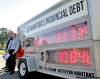 JOE BRYKSA / WINNIPEG FREE PRESS 
The Canadian Taxpayers Federation’s Colin Craig (right) with the Frontier Centre’s Peter Holle and the Manitoba debt clock at the Manitoba legislature.