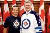Stephen Harper (right) models the Jets' away jersey alongside Winnipeg South MP Rod Bruinooge. It's expected the prime minister will be in town for the opener against Montreal on Oct. 9.