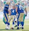 TREVOR HAGAN/WINNIPEG FREE PRESS
Obby Kahn and Brendon Labatte hoist up woozy QB Buck Pierce after he was devastated by a hard hit in the first quarter.