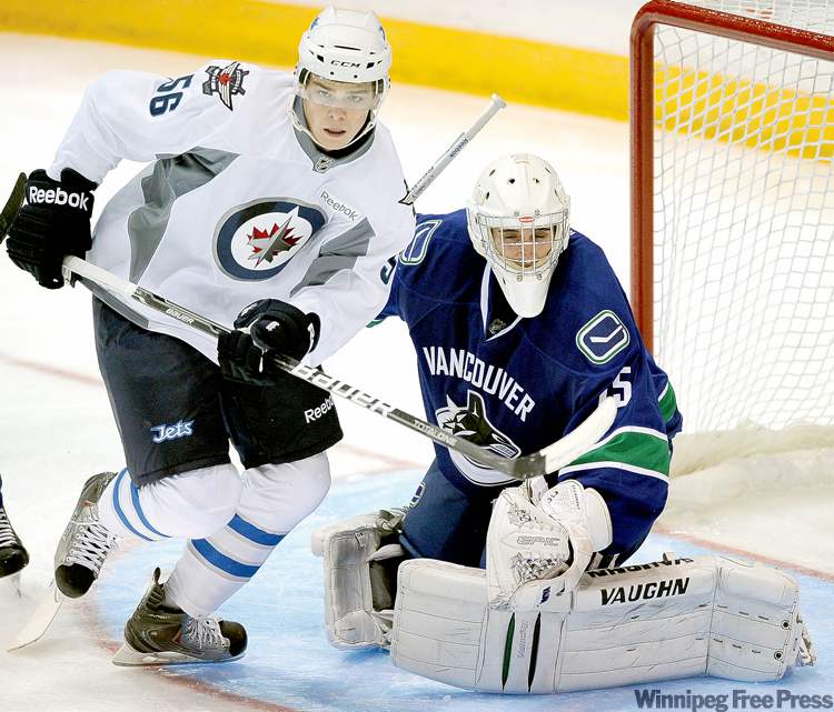 CNS Larry Wong/Edmonton Journal/
Larry Wong / postmedia news
Adam Lowry skates in front of Vancouver Canucks goalie Karel St. Laurent on Thursday during the Winnipeg Jets� final game in the Young Stars Tournament.