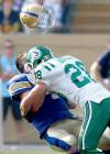 JOE BRYKSA / WINNIPEG FREE PRESS archives
Buck Pierce's helmet takes off like a MiG 35 after he's belted by Saskatchewan's Craig Butler in the Banjo Bowl.