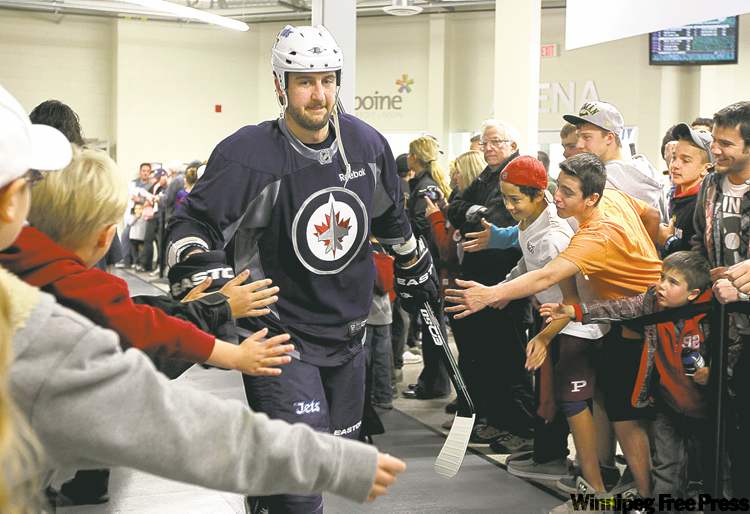 Winnipeg Jet Tanner Glass gets cheered on as he makes his way to the ice.