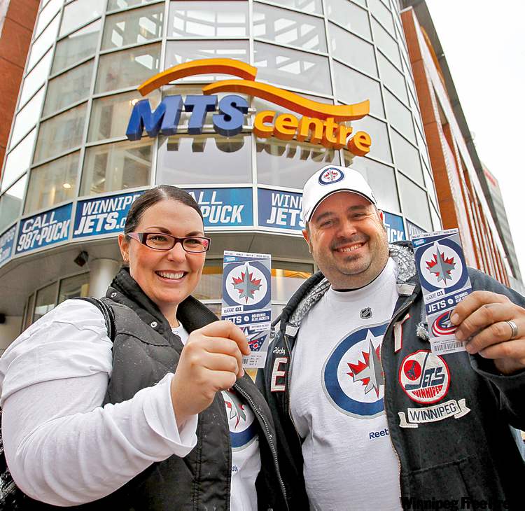WAYNE GLOWACKI / WINNIPEG FREE PRESS
Ian Buckingham and his wife, Ami, show off their tickets outside the MTS Centre Tuesday.