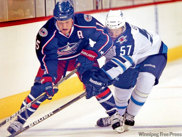 PHIL HOSSACK / WINNIPEG FREE PRESS
Jets’ Jason Gregoire sticks like glue to Blue Jackets’ Derek Dorsett in the first period Tuesday.