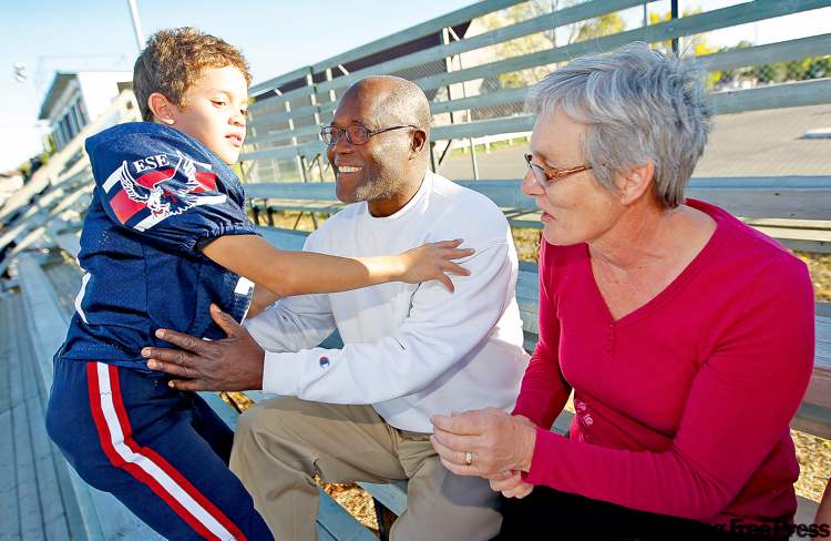 TREVOR HAGAN / WINNIPEG FREE PRESS
Owen Cassie, 8, and grandparents Alix and Gertrude Jean-Paul at a football game near an advance polling station. Alix Jean-Paul doesn’t expect change after the election.