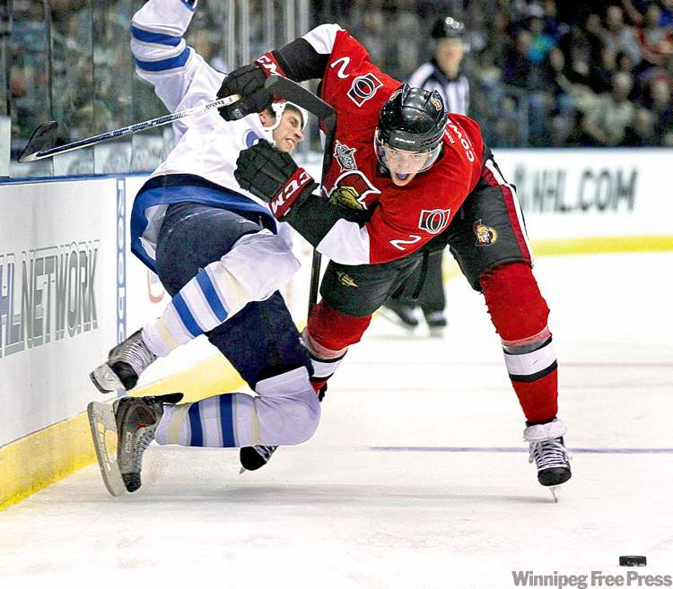 Paul Daly / The Canadian Press
Senators defenceman Jared Cowen sends Jet Troy Bodie flying.