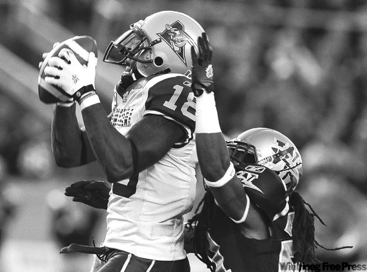 Jason Halstead / The Canadian Press
Alouettes slotback Jamel Richardson makes a catch in front of Blue Bombers defensive back Alex Suber.