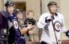 WAYNE GLOWACKI / WINNIPEG FREE PRESS
Winnipeg Jets fans Terry McCormack and his son Liam, 2, watch Mark Scheifele (left) and Alexander Burmistrov practise at the MTS Iceplex Thursday.
