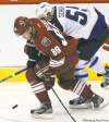 JOE BRYKSA / WINNIPEG FREE PRESS
Jets forward Mark Scheifele (rear) tries to steal the puck from Coyotes� Mikkel Boedker in the third period Saturday in Phoenix.