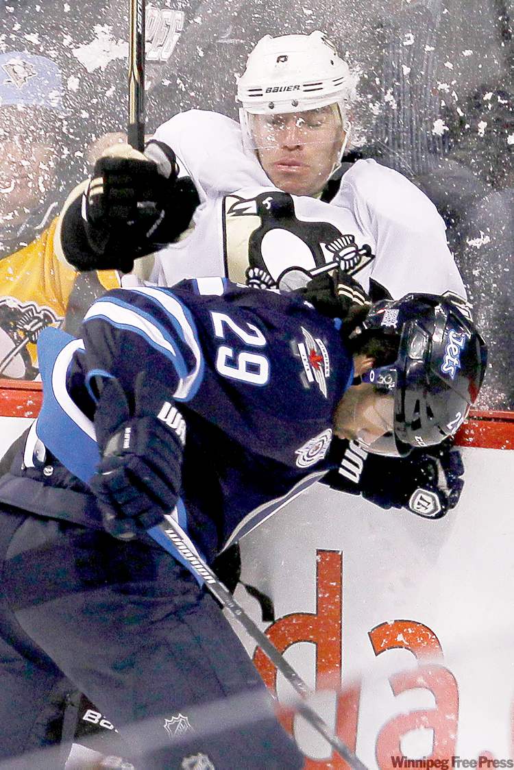 CP
John Woods / the canadian press archives
Jets defenceman Johnny Oduya takes out Pittsburgh Penguins forward Pascal Dupuis on Monday night.