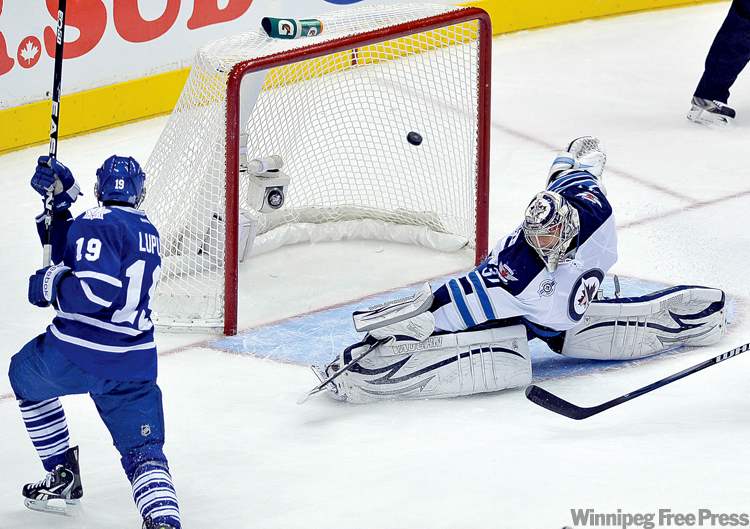 REUTERS
Mike Cassese / reuters
Toronto forward Joffrey Lupul rips one past Winnipeg goalie Ondrej Pavelec during the first period of the lone NHL game on Wednesday.